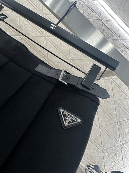 Mid length pleated skirt with waist belt