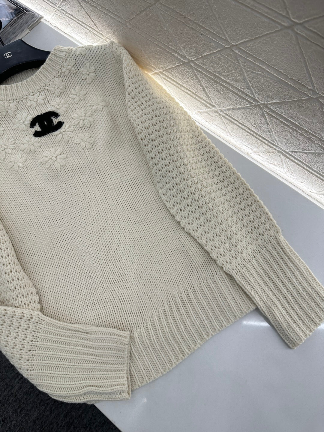 Knitted sweater with hook and loop design
