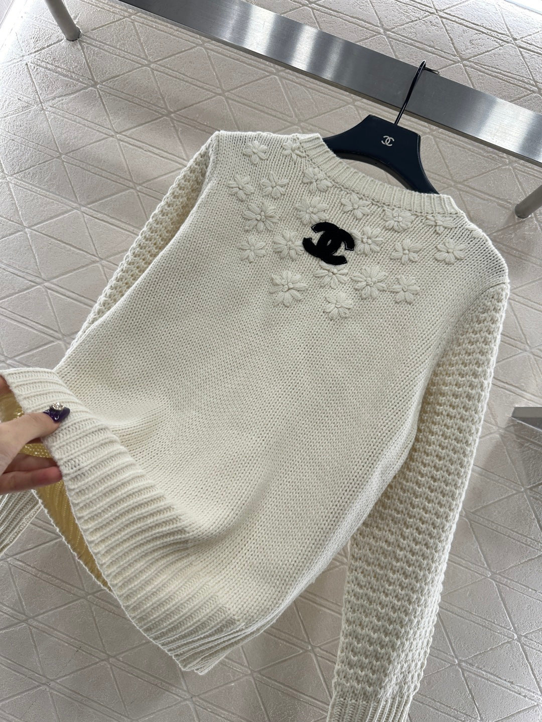 Knitted sweater with hook and loop design