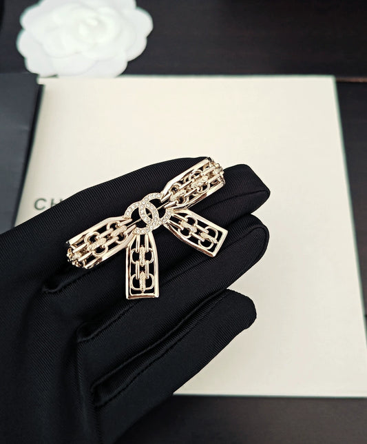 Light gold hollow bow brooch