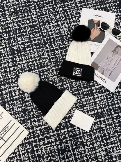 Black and white contrasting ball knitted hat