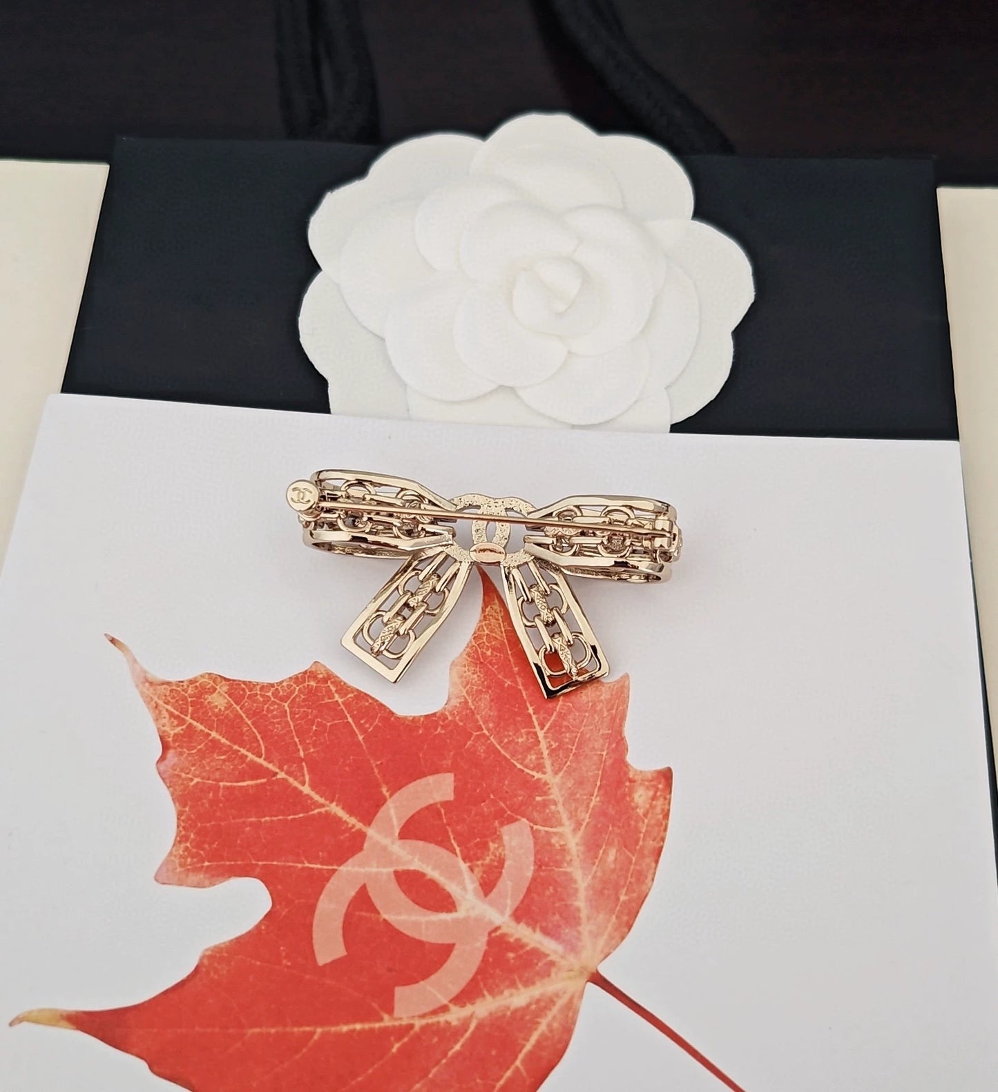 Light gold hollow bow brooch