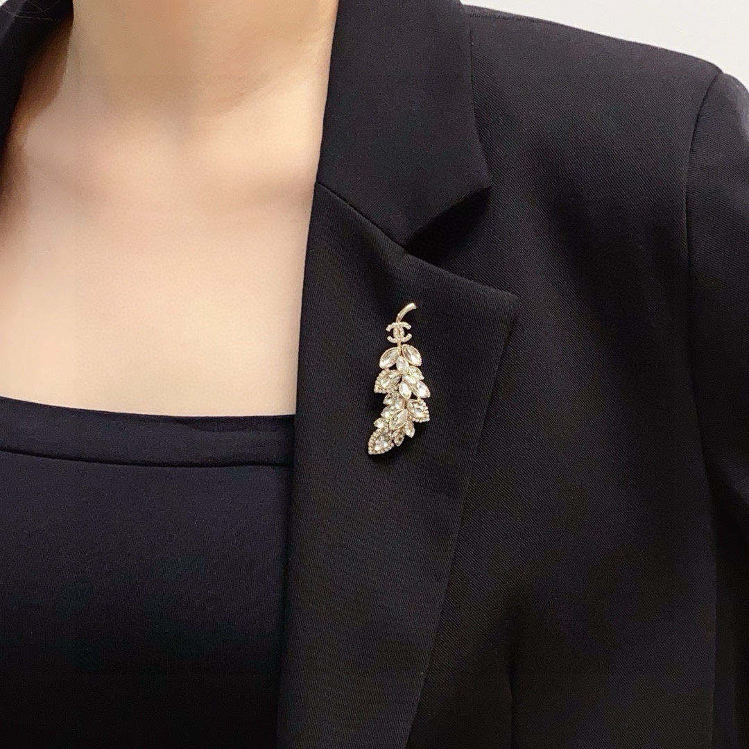 logo brooch