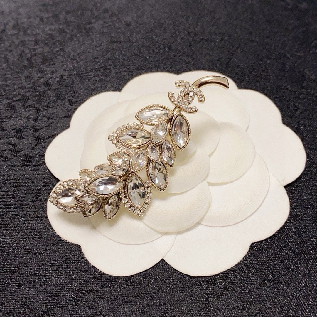 logo brooch