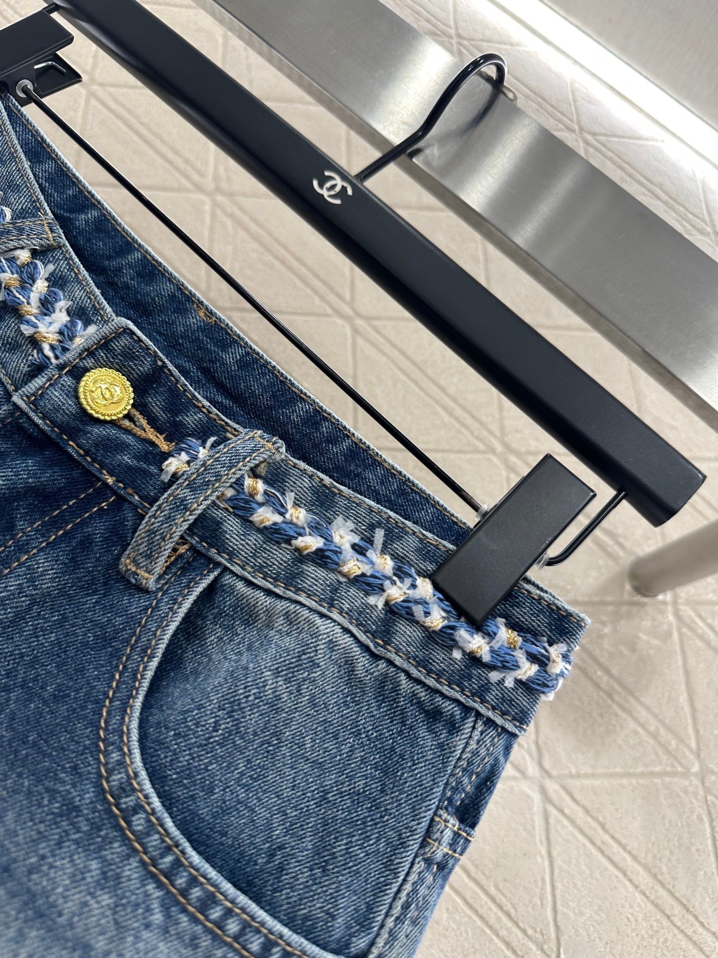 25 High-waisted bleached pleated denim trousers