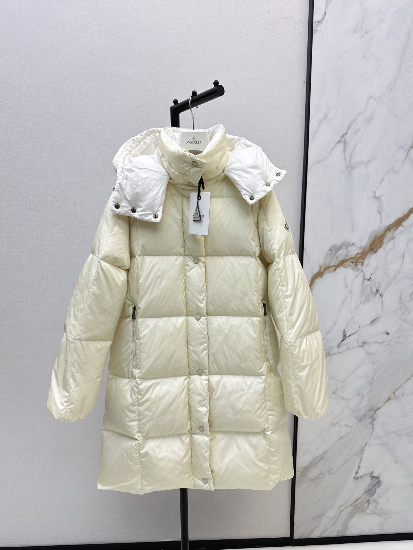 mid-length down jacket with hood and sleeve badge