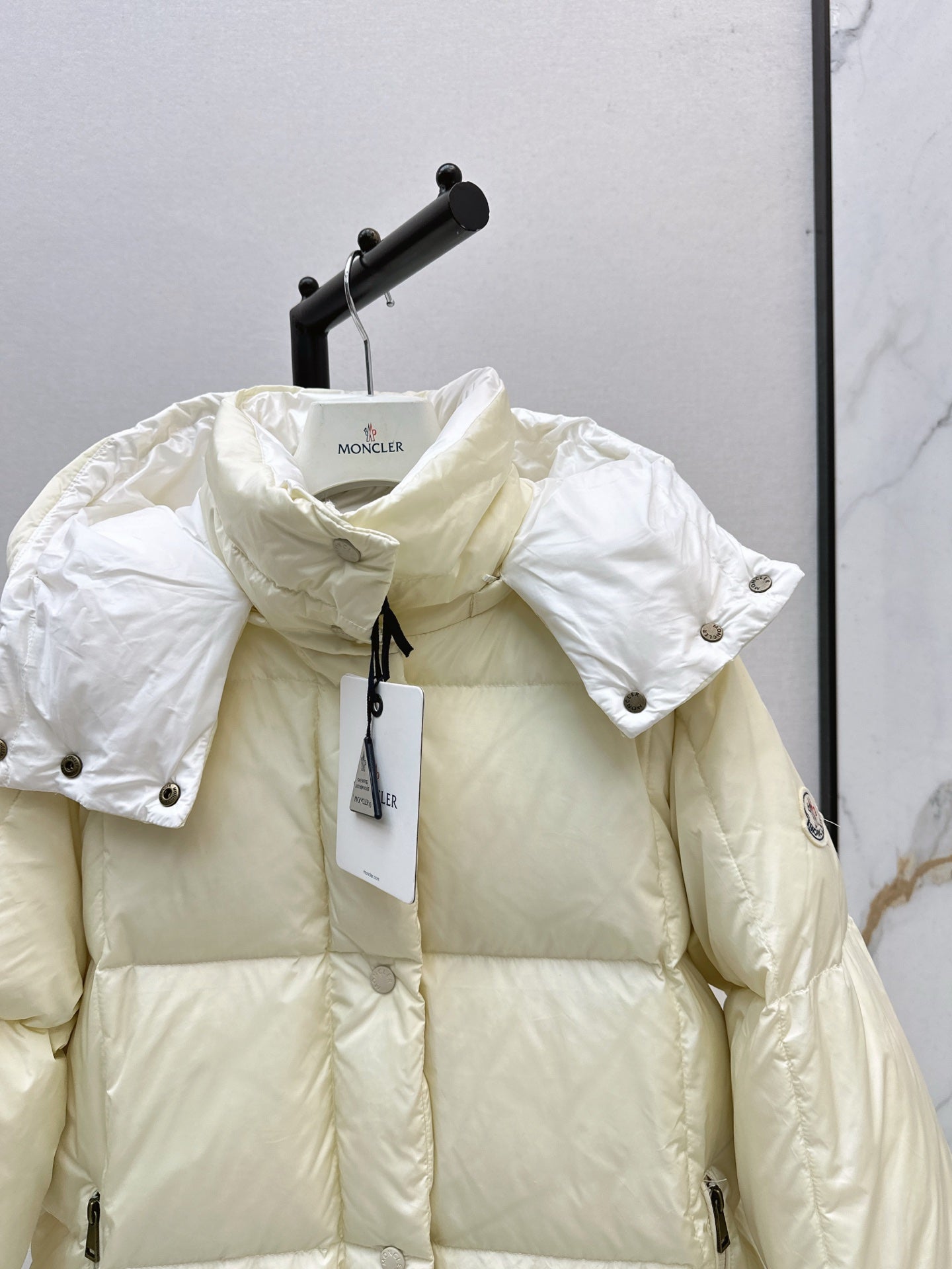mid-length down jacket with hood and sleeve badge