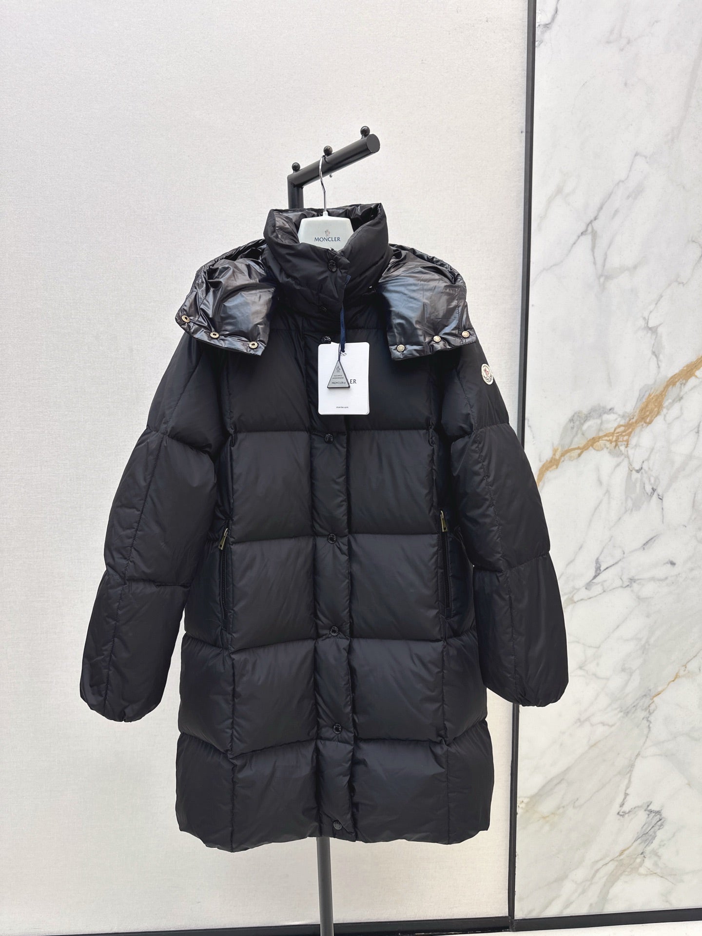 mid-length down jacket with hood and sleeve badge