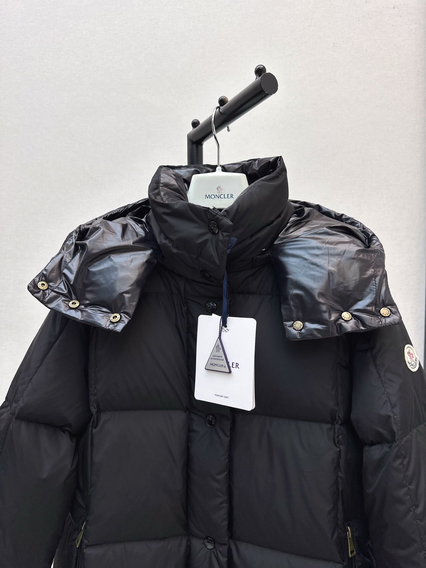 mid-length down jacket with hood and sleeve badge